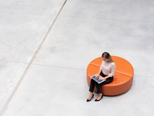 Professional business woman working on her laptop in a modern office