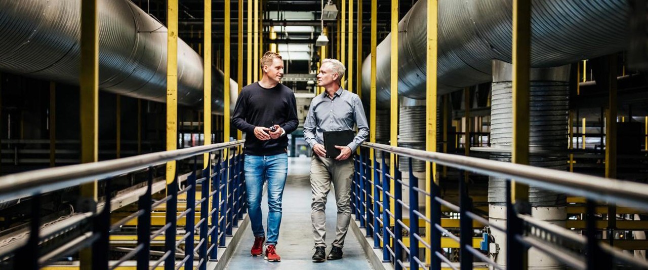 two man walks in factory