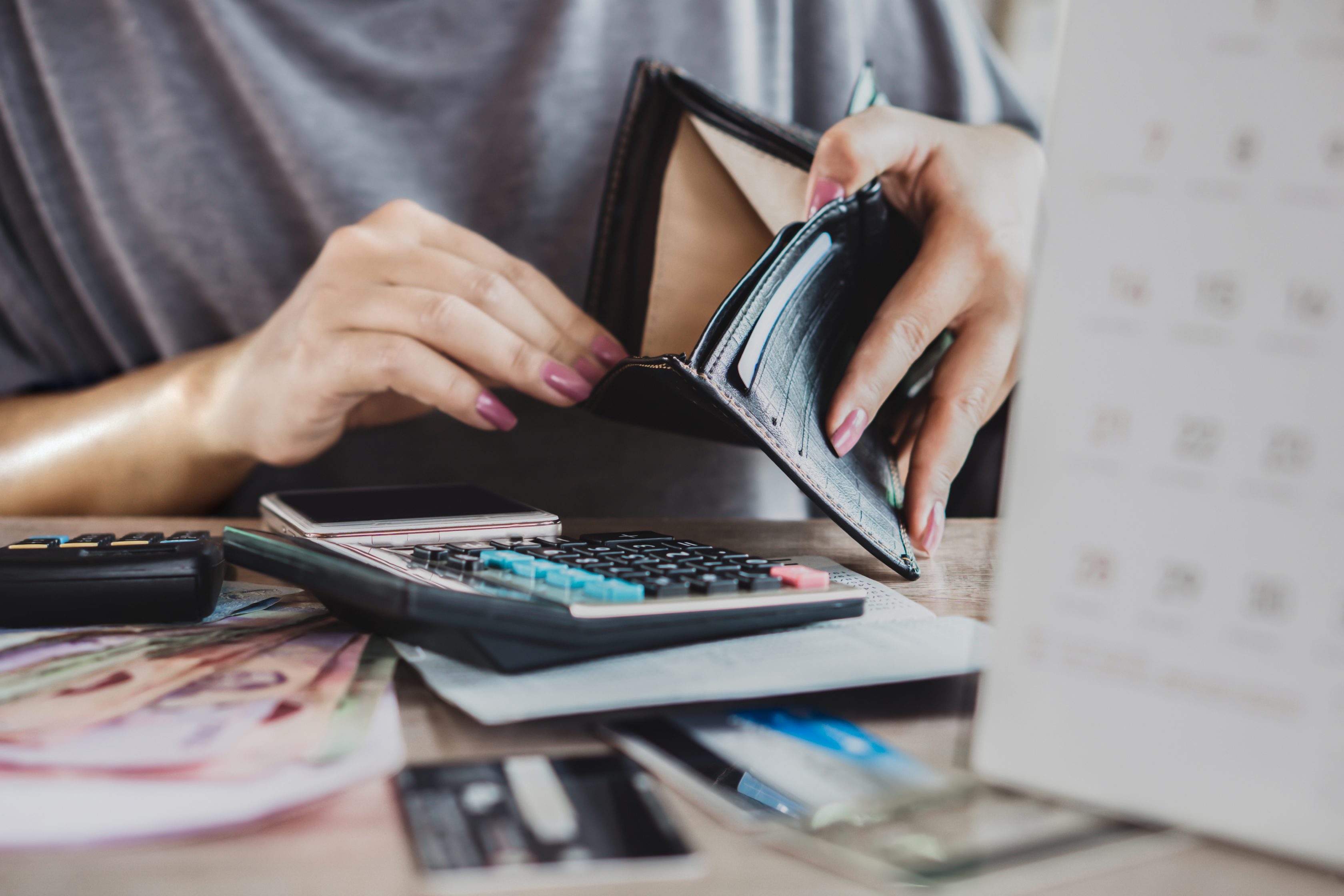 a person is looking inside a wallet