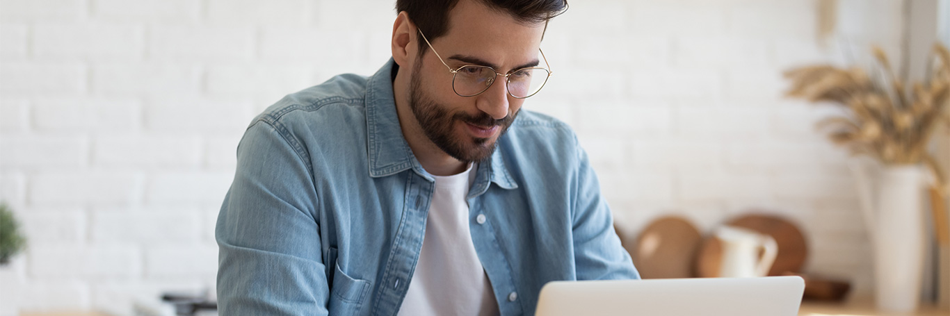 A man is looking at his laptop