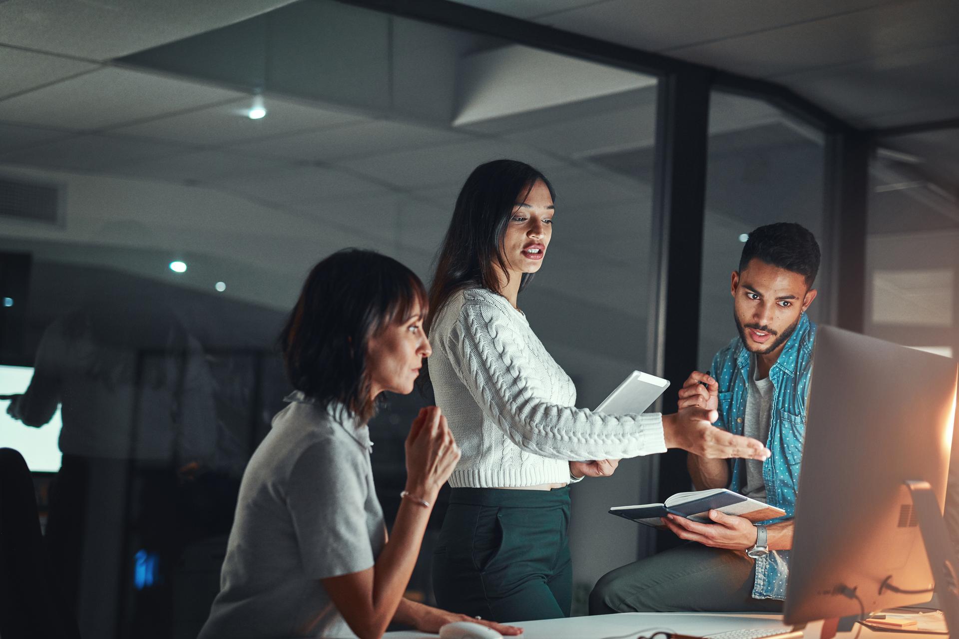 three-people-discuss-facing-computer-screen-hero