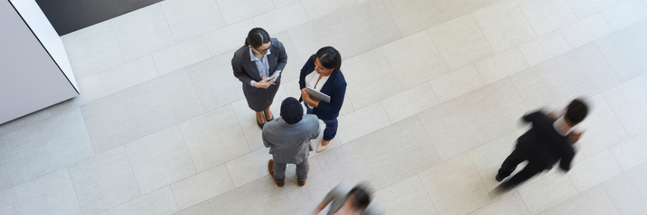 Directly-above -view-of-intercultural business colleagues in formalwear standing in lobby of company