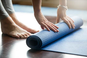 yoga mat being rolled up