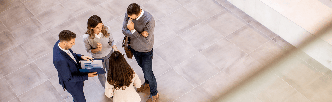 four-business-people-analyzing-graphics-and-having-a-meeting