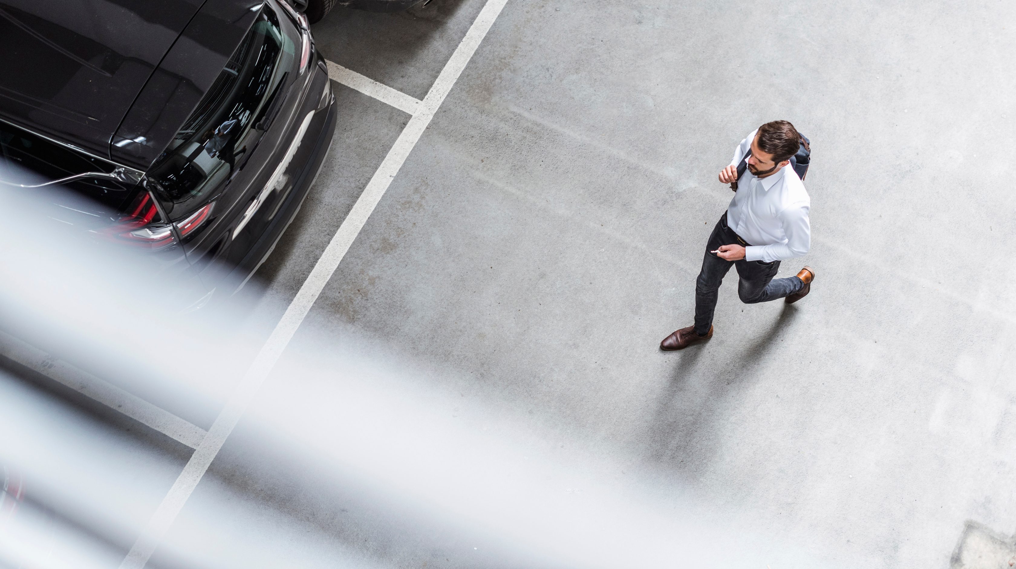 birds-eye view of man walking in parking lot