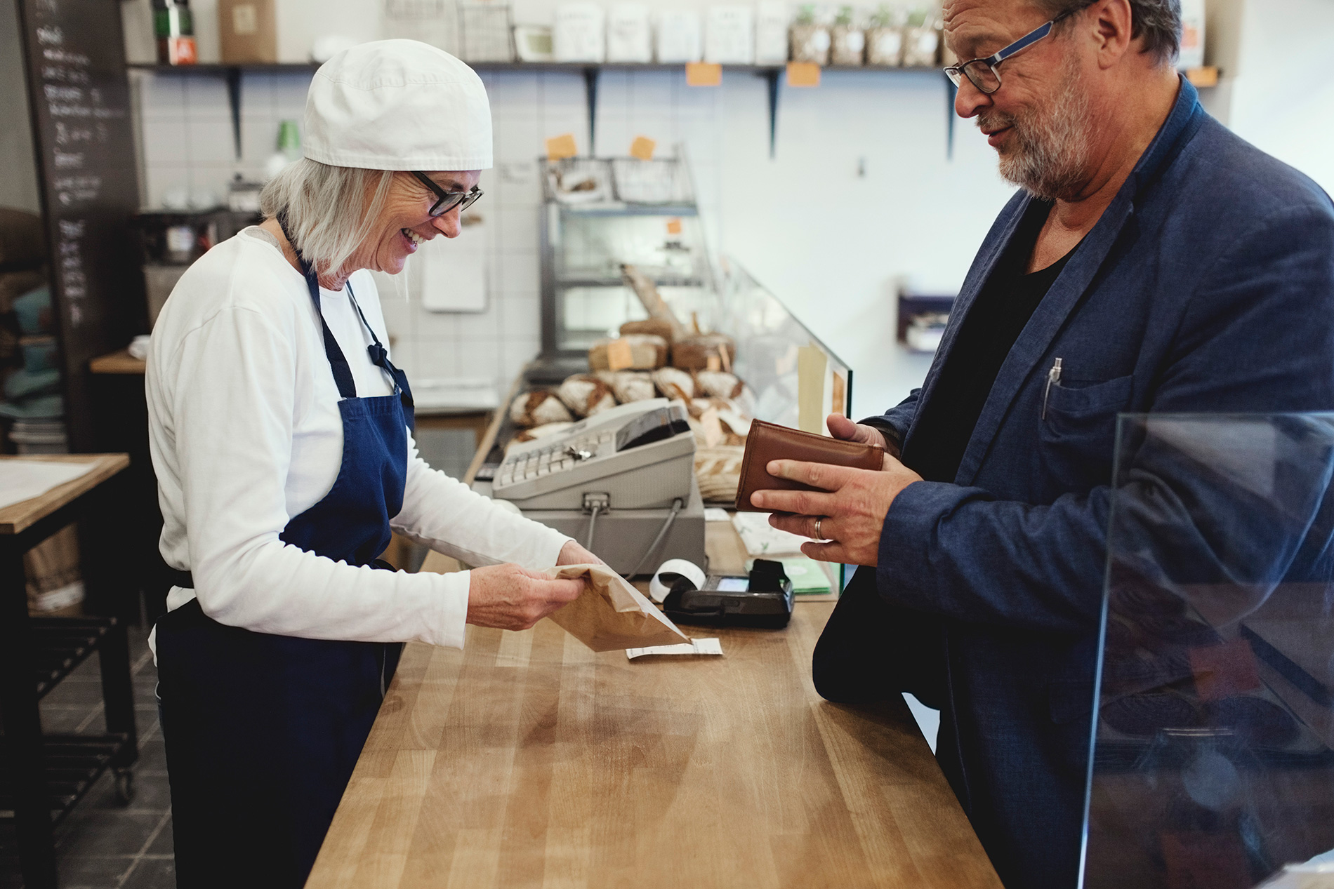 man with wallet at bakery