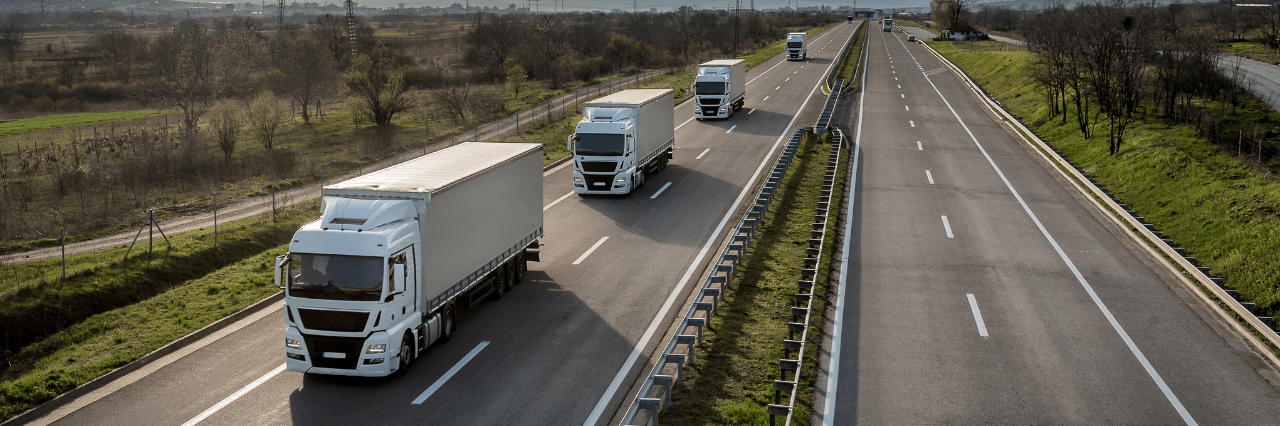 multiple semi trucks on a highway