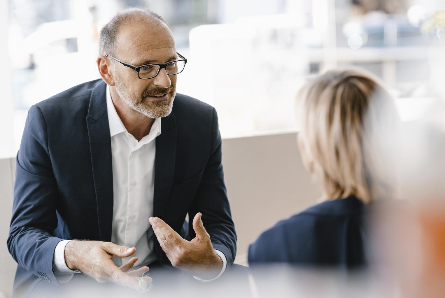 co-workers talking in office setting