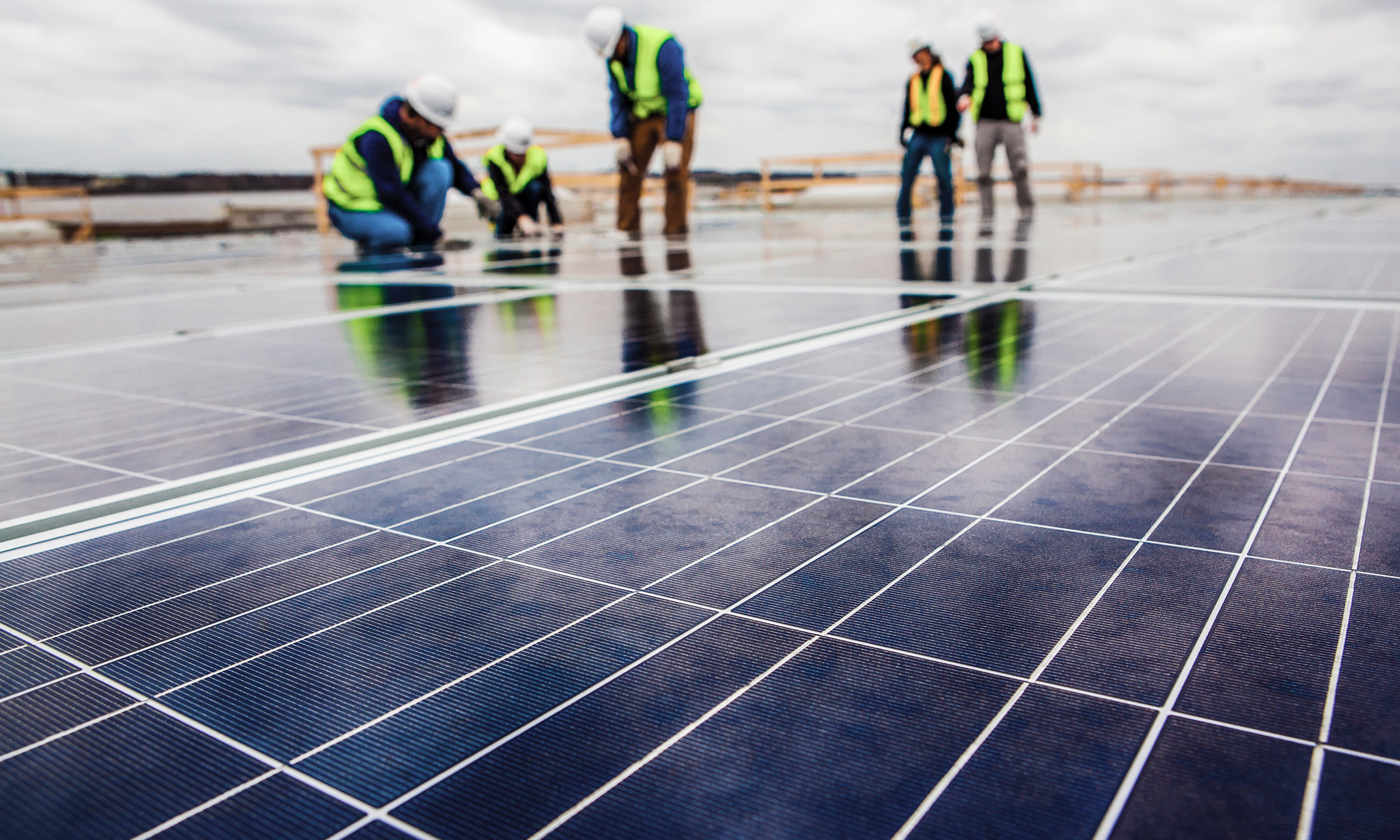 workers with solar panels