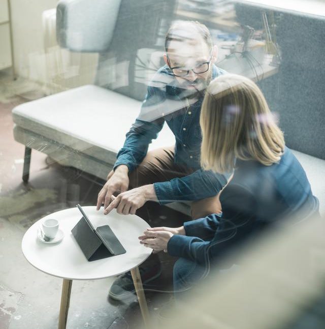Two people discussing on a couch
