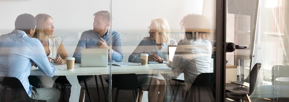 Business people negotiating at boardroom behind closed doors