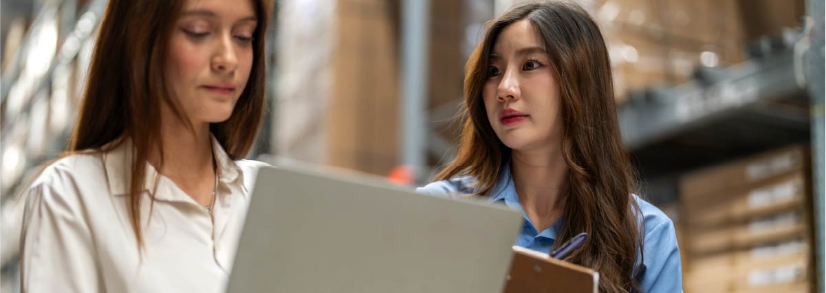 shipping inventory check with laptop and clipboard